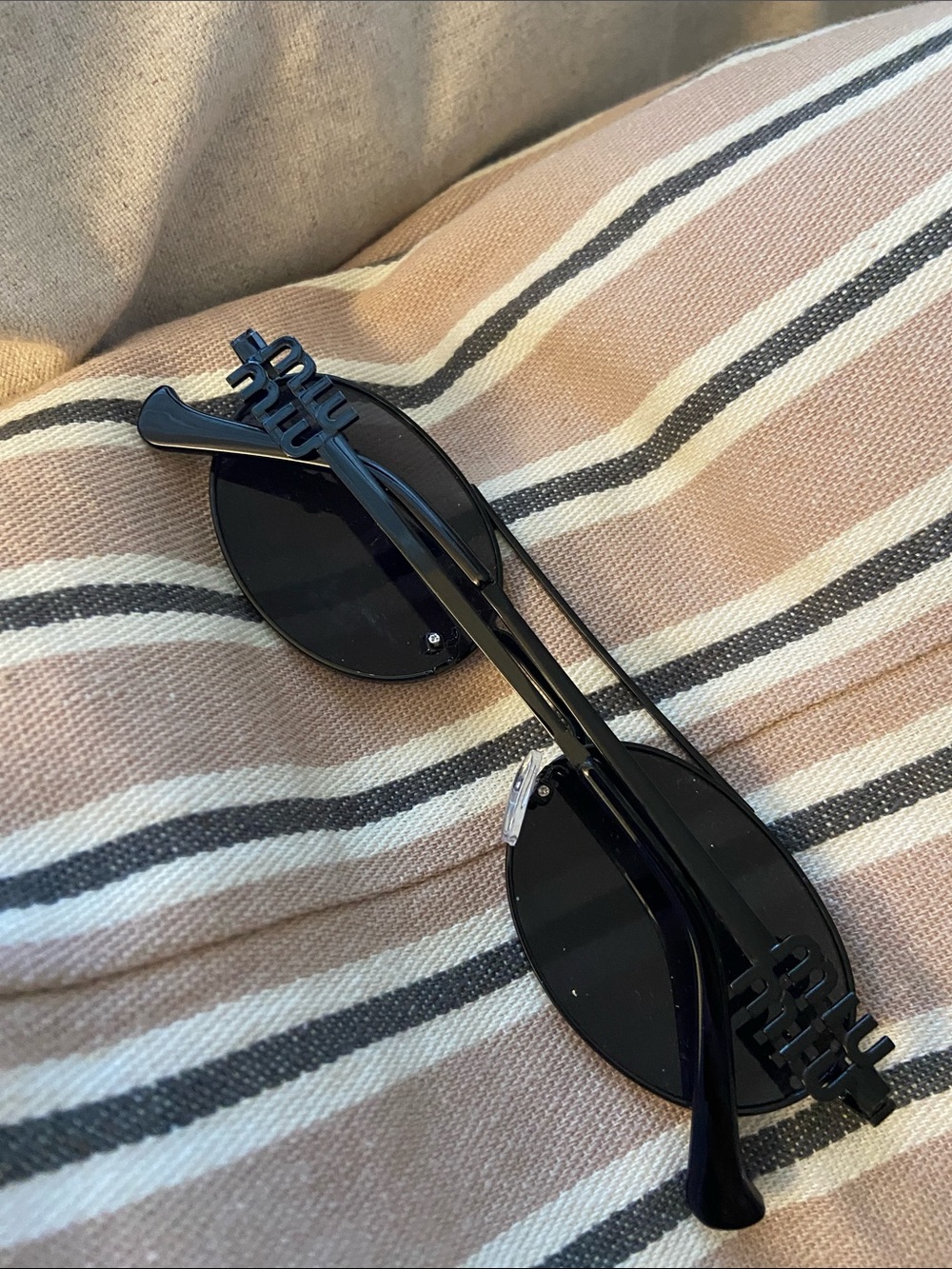 Black Miu Miu labeled sunglasses oval frame